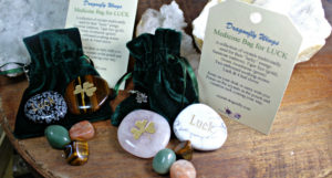 Luck Medicine Back with assorted tumbled & polished stones, a velvet pouch and a shamrock charm
